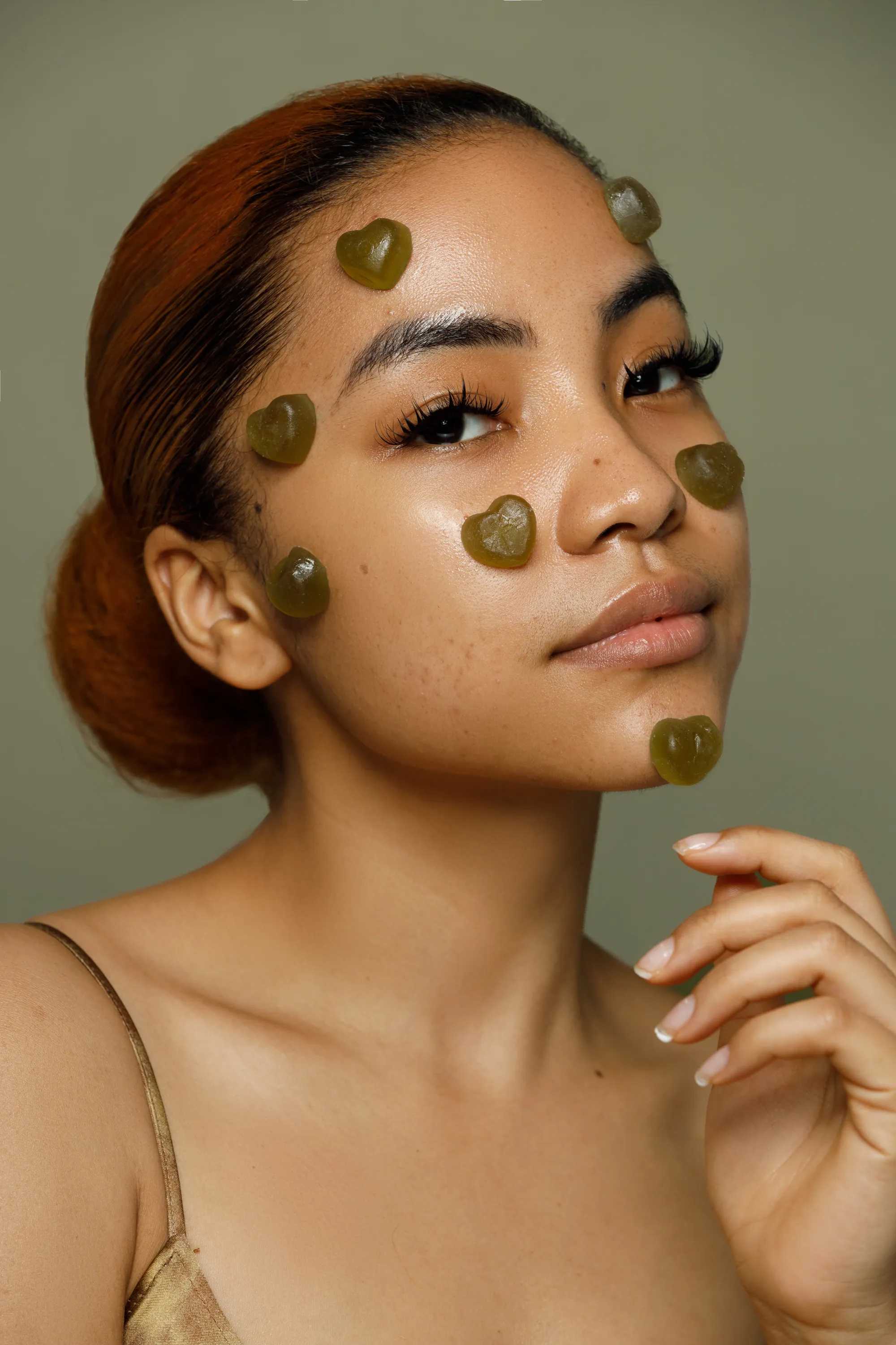 Striking portrait of a woman with a colorful headwrap and elegant makeup.